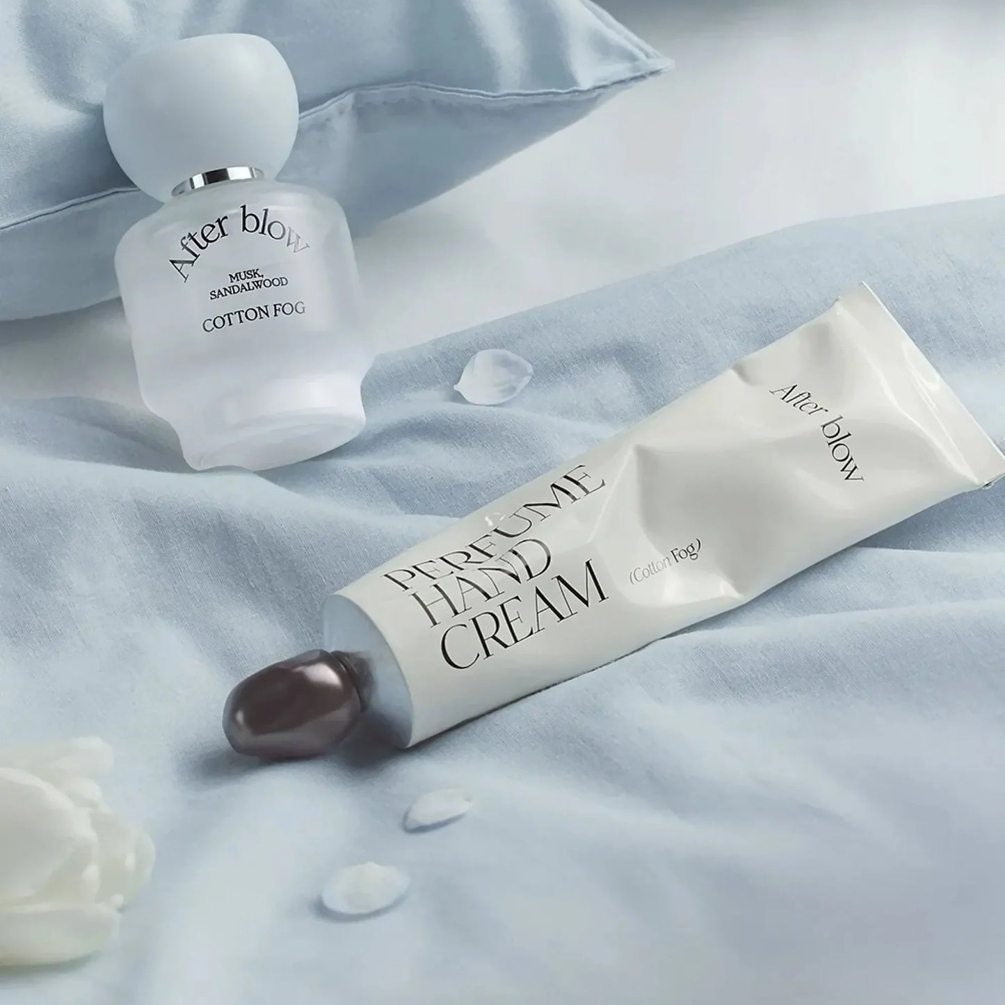 Afterblow Cotton Fog hand cream styled with perfume and soft linen.