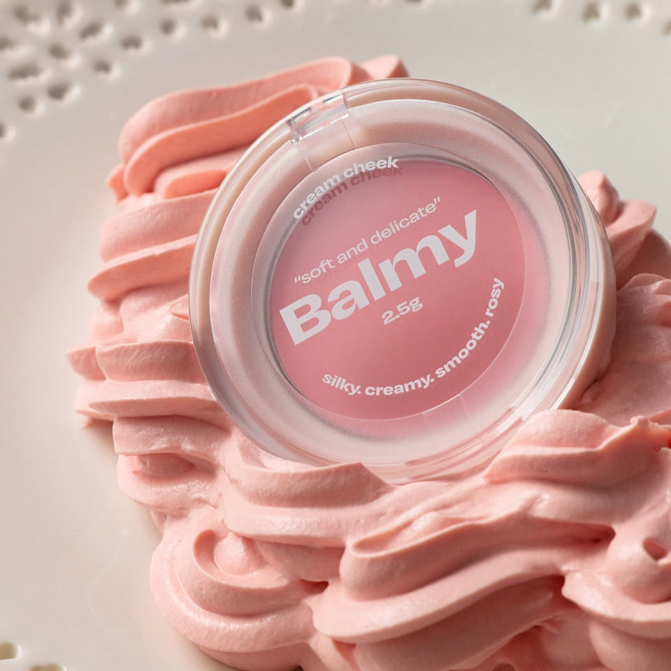 Alternative Stereo Balmy Cream Cheek placed on soft pink whipped cream texture for a dreamy product vibe.