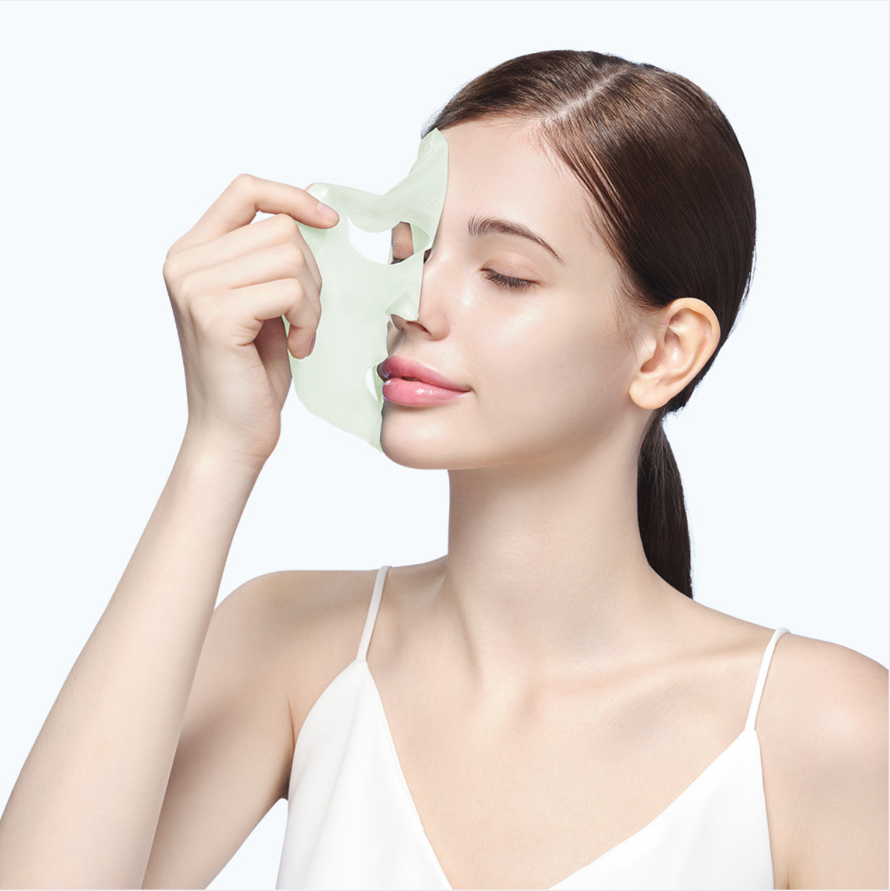 Model holding Dermafix CICA Collagen Mask showing skin-calming and soothing benefits.