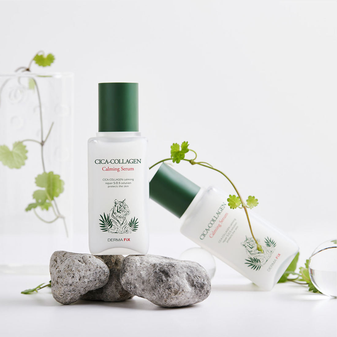 Dermafix Cica-Collagen Calming Serum styled with rocks and fresh green leaves for a nature-inspired look.