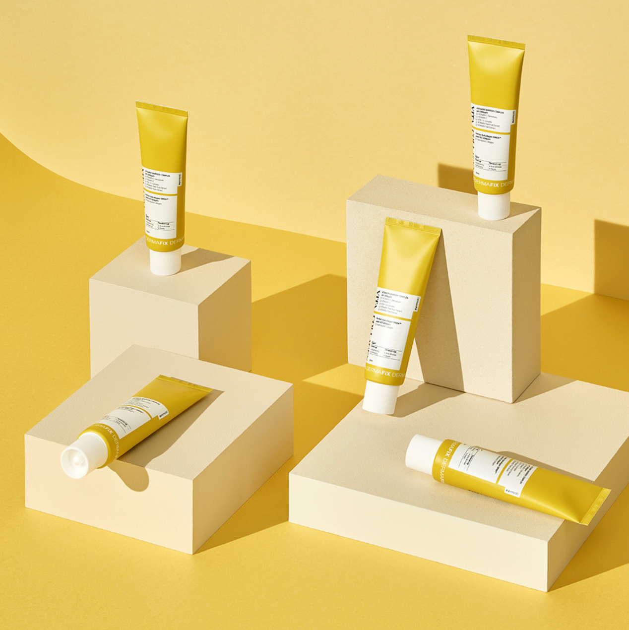 Display of Dermafix Vita Collagen Cream tubes on beige blocks with soft shadows.