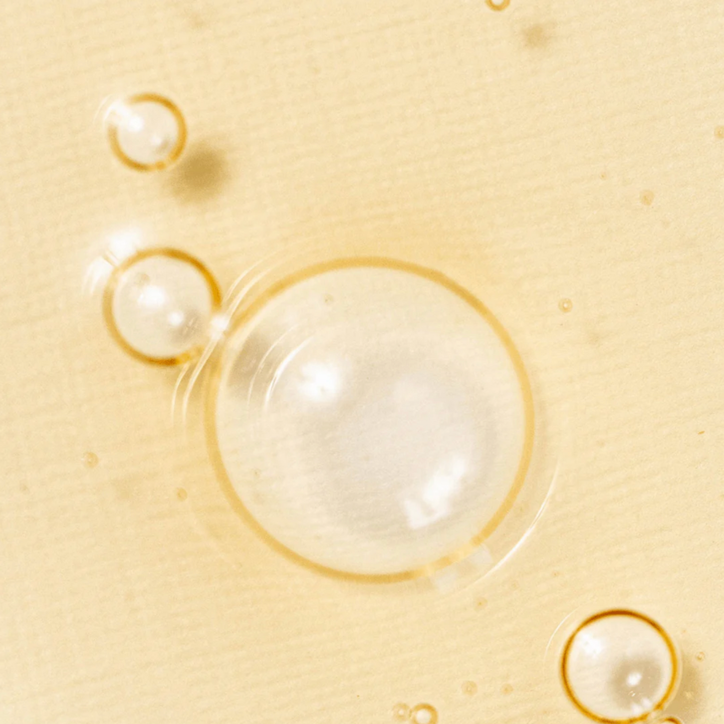 Close-up of Beauty of Joseon Revive Serum Ginseng and Snail Mucin texture with clear bubbles.