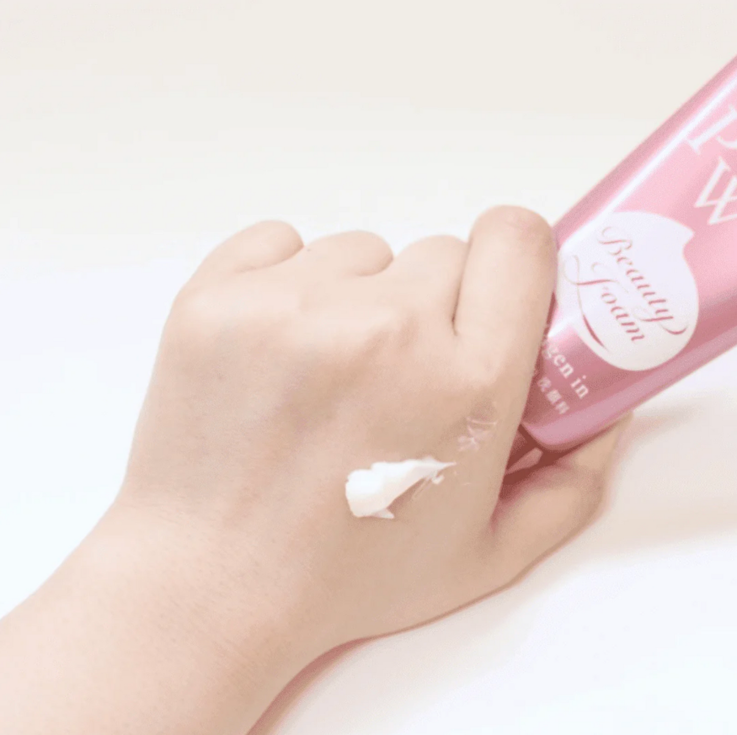 Applying SENKA Collagen Foam Cleanser on hand to show creamy texture and deep moisture cleansing.