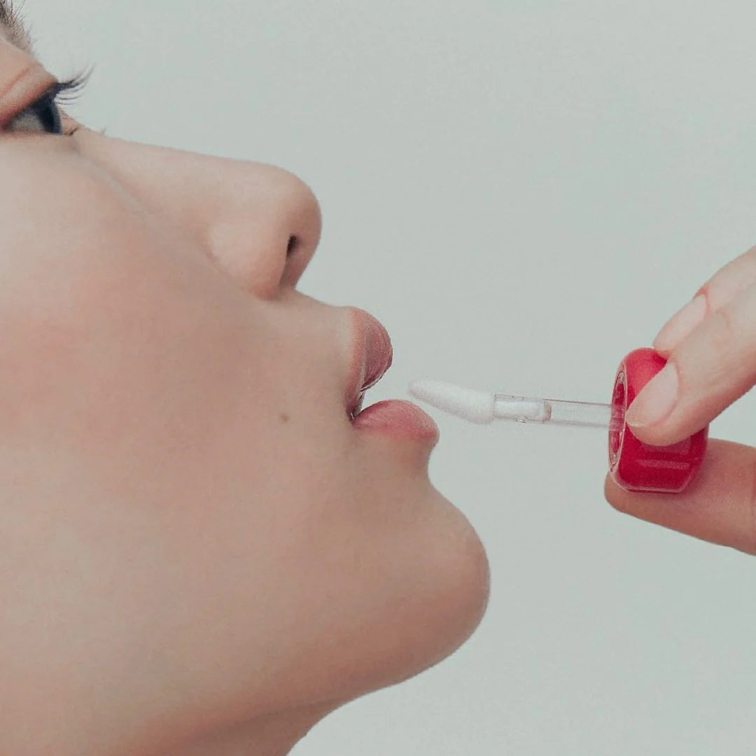 Close-up of lips applying Alternative Stereo Steaming Milk – white applicator tip, subtle shine.
