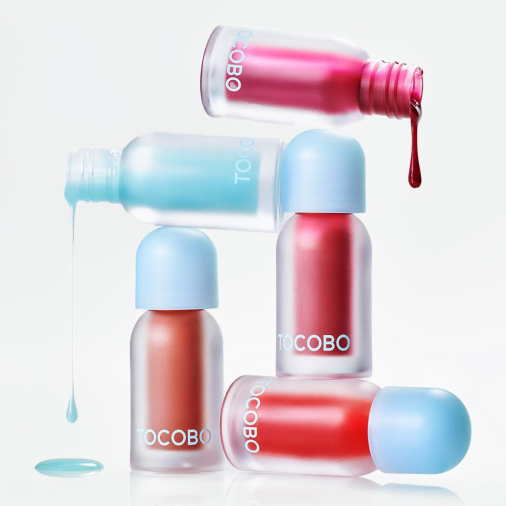 TOCOBO lip oils in colorful shades stacked with drips.