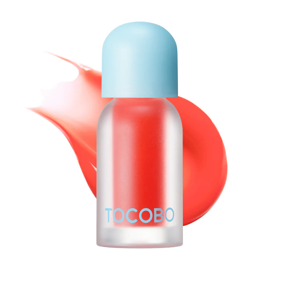 Red TOCOBO lip oil bottle with coral swatch background.