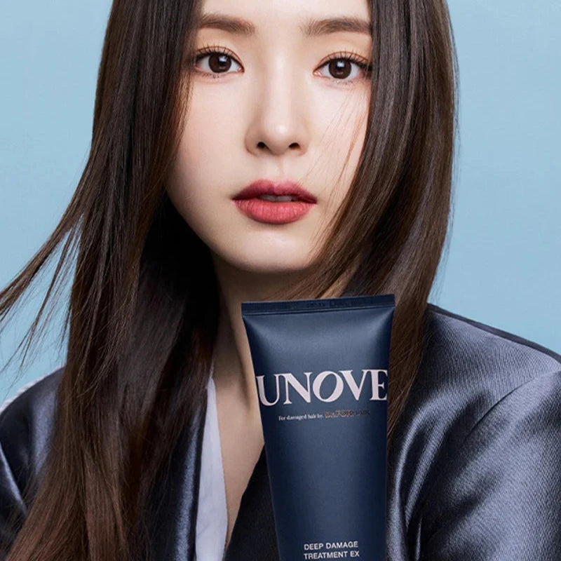 Model holding UNOVE Deep Damage Treatment EX for damaged hair care.