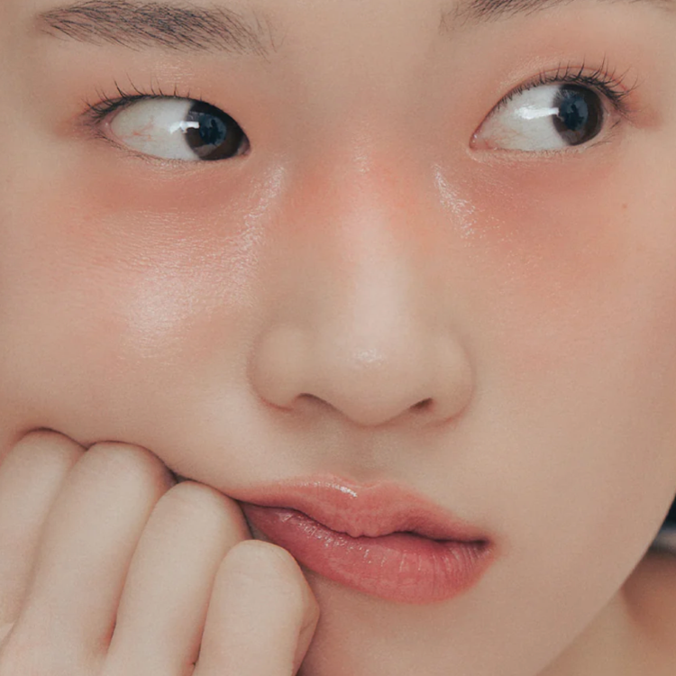 Close-up of lips and cheeks wearing Alternative Stereo Aqua Glow – dewy skin and peachy tint.