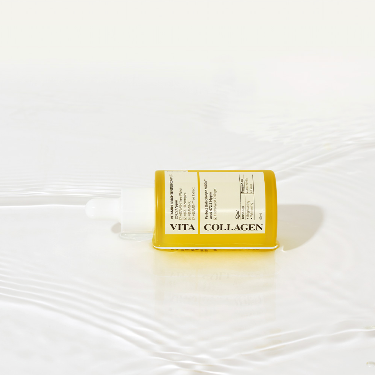 Single Dermafix Vita Collagen ampoule lying on rippled water surface.