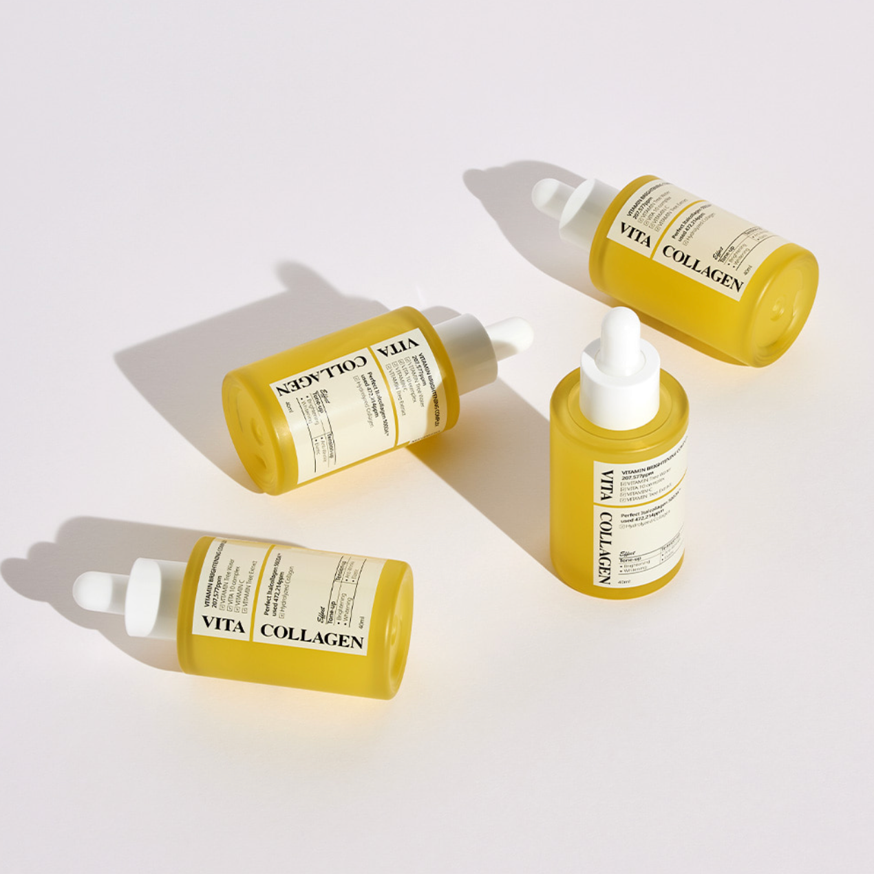 Four Dermafix Vita Collagen ampoules placed on light background with bold shadows.