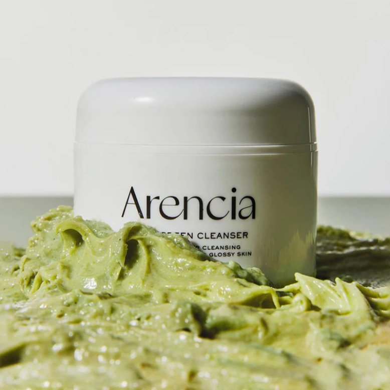 Arencia cleanser surrounded by green cleansing cream.