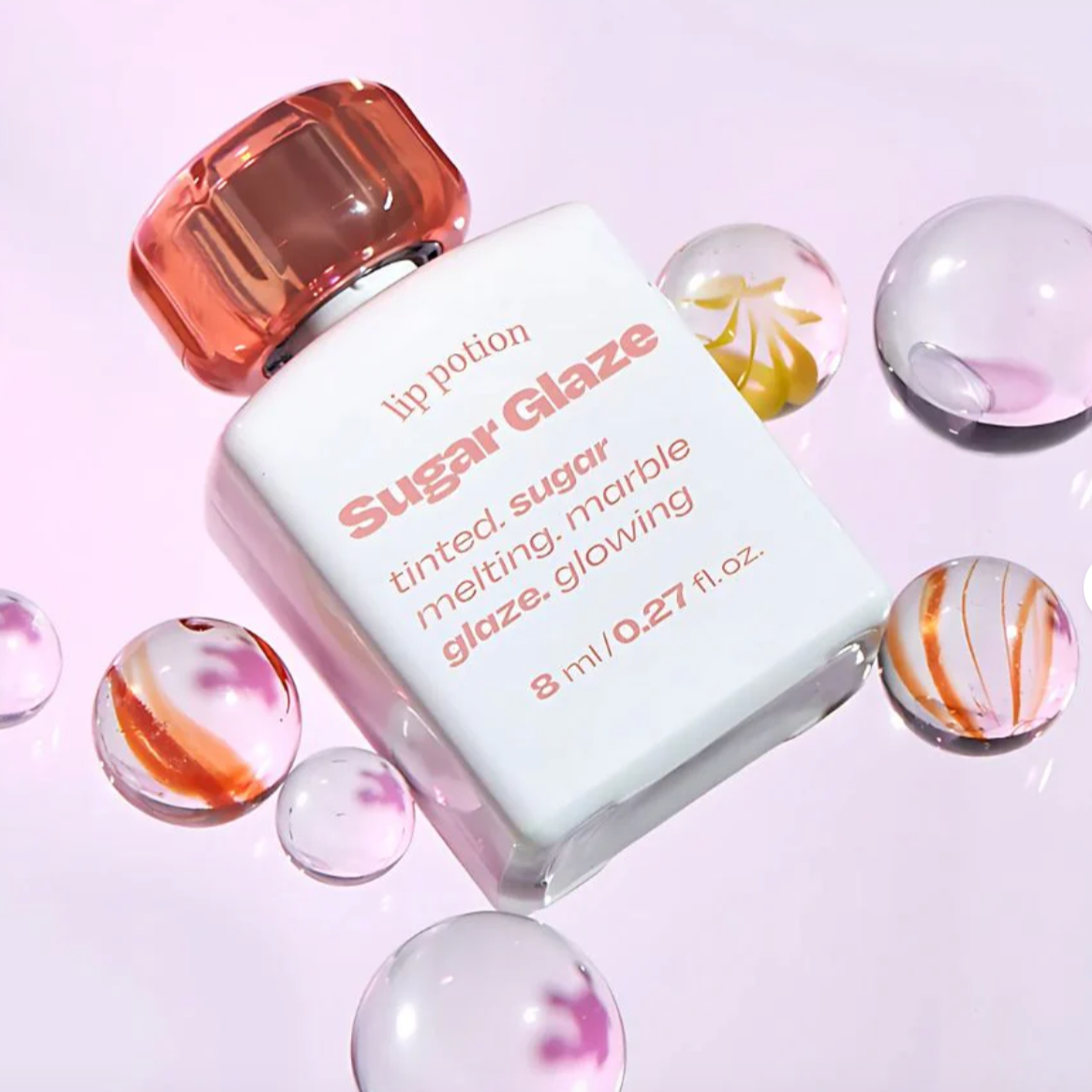 Close-up of Alternative Stereo Lip Potion Sugar Glaze with marble textures – non-sticky, moisturizing tint.